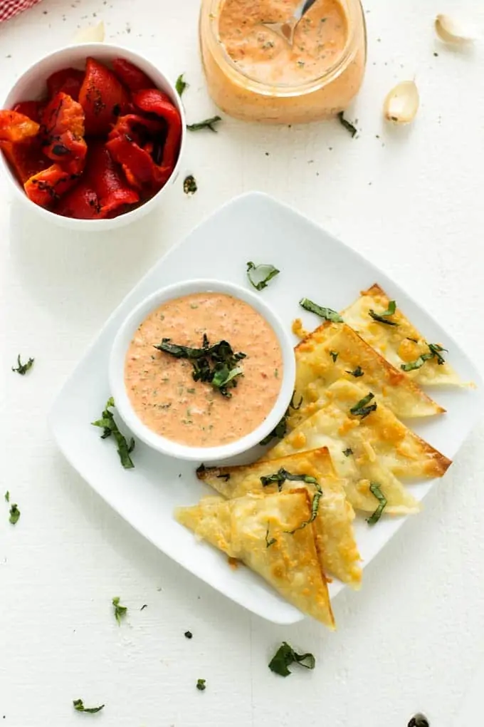 Photo of Goat Cheese Wontons, a bowl of roasted red peppers and a bowl of roasted red pepper garlic sauce
