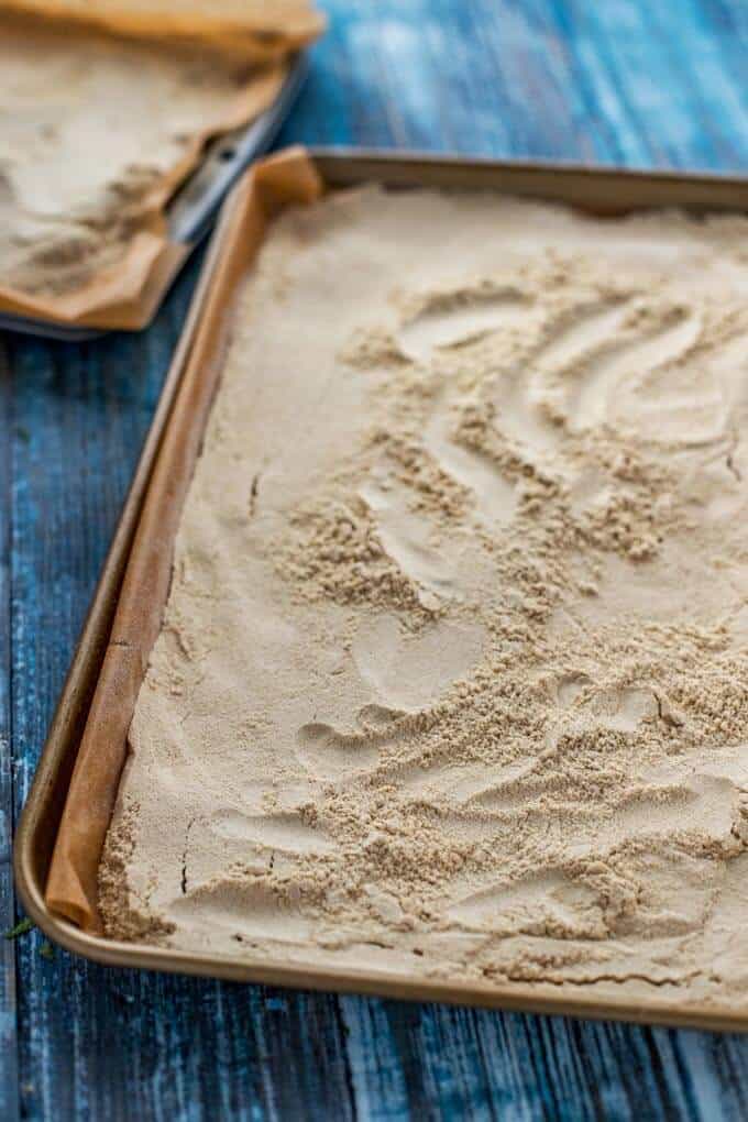 Photo of quinoa flour on a baking sheet prepared to go in the oven.