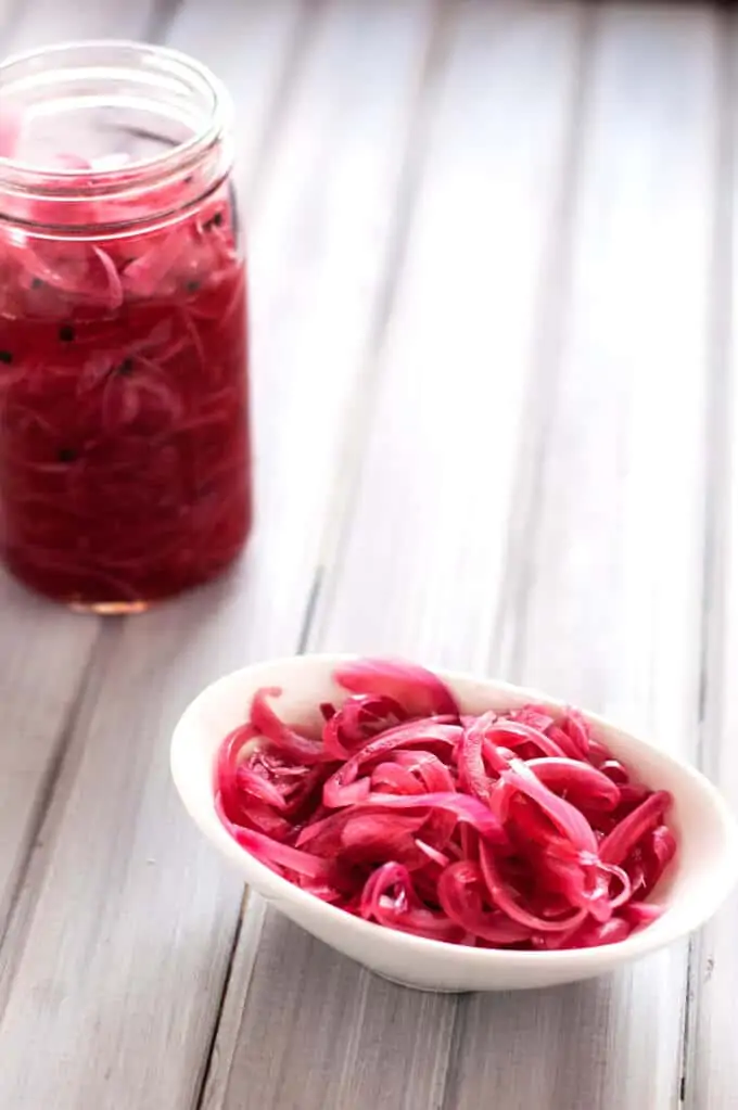Image of a jar and bowl of quick pickled onions.