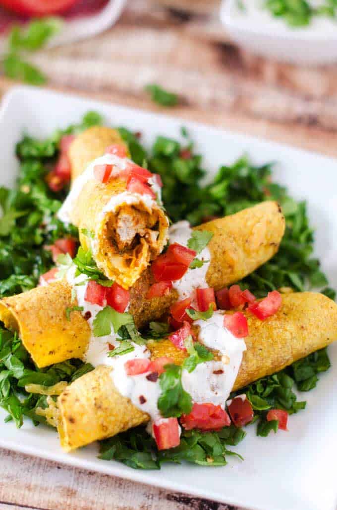Photo of prepared Baked Chicken Taquitos Recipe with one taquito facing the camera.
