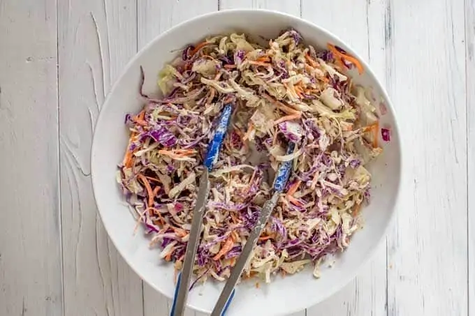 Photo of slaw being mixed together.