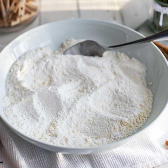 Second process photo for DIY Laundry Detergent - Ingredients are mixed together in a large white bowl.