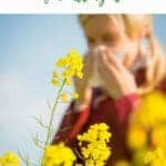 Photo of a woman sneezing behind a flower with the caption Essential Oils for Allergies