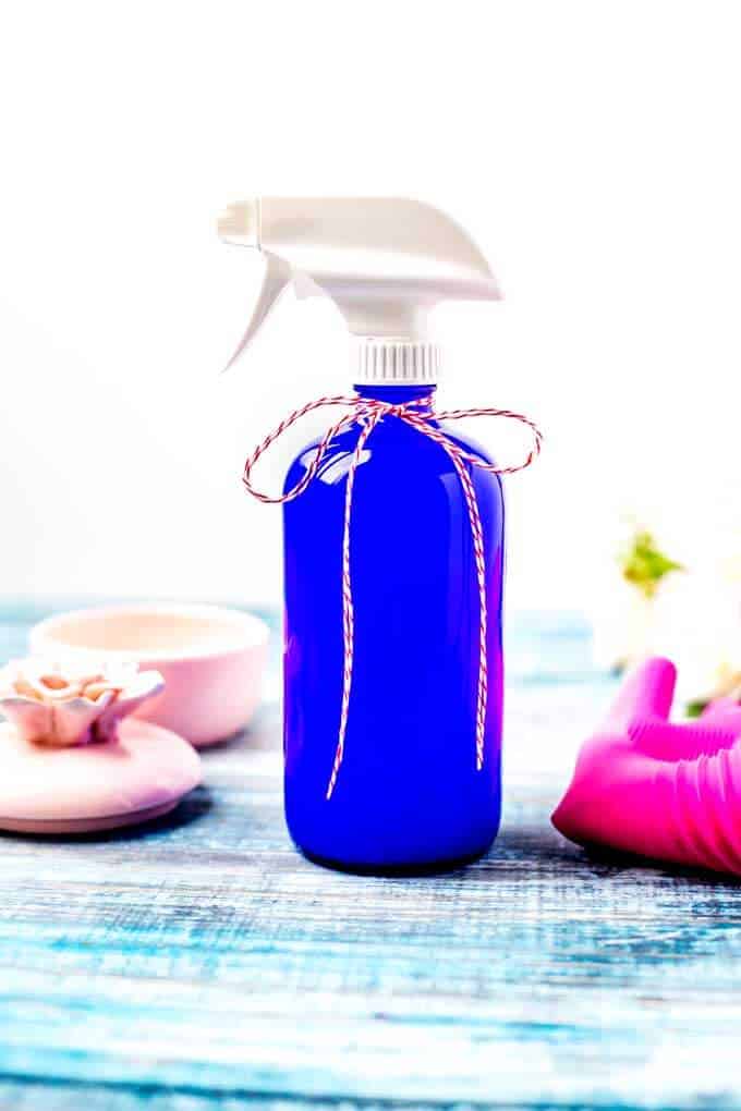 Photo of DIY all purpose cleaner in a blue glass bottle.