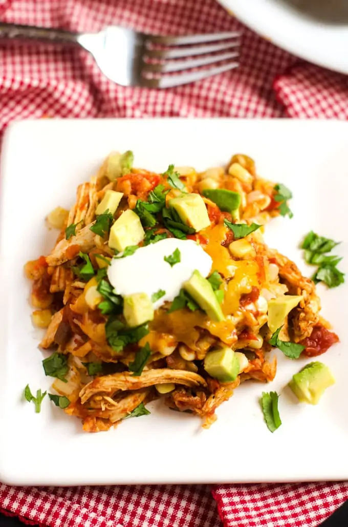 Close up photo of Slow Cooker Mexican Casserole garnished with cilantro and avocado.