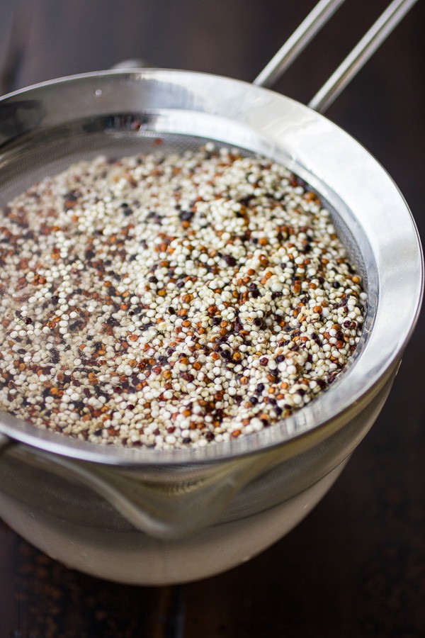 Photo of dry quinoa in a fine metal strainer measured to make a Beet Burger Recipe.