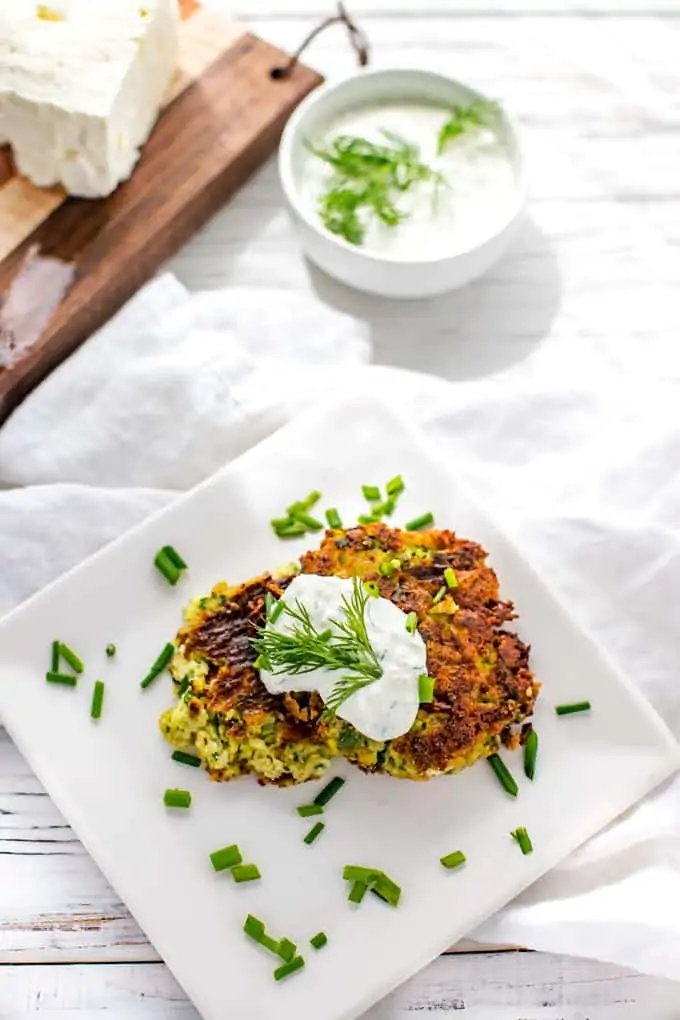 Overhead Photo of Zucchini Fritters Recipe with Feta prepared and plated on a white plate.