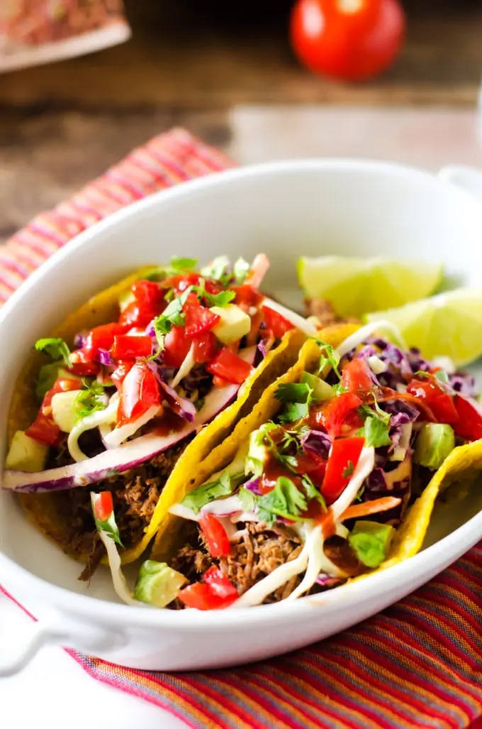 Close up photo of Shredded Beef Tacos with Chipotle Lime Slaw in a white bowl.