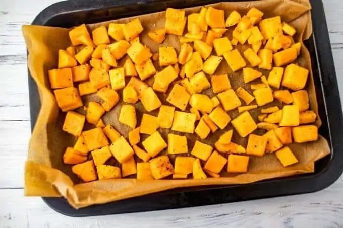 Cubed Butternut Squash in a roasting pan.