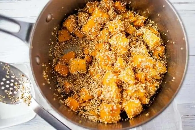 Quinoa and Butternut Squash being added to the pan to cook.