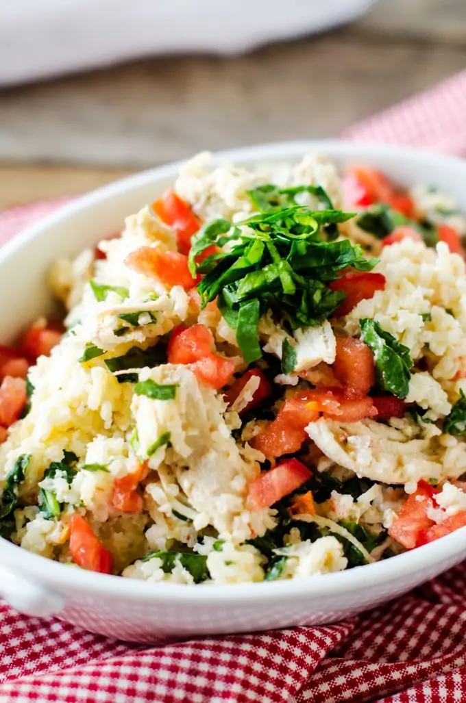 Slow Cooker Chicken and Rice with Feta and Spinach - This Slow Cooker Chicken and Rice is a fun twist on Chicken & Rice! I've added spinach, feta and tomato for a bit of a Mediterranean twist.