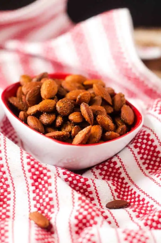 Spicy Slow Cooker Almonds in a small bowl on a red and white towel