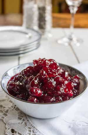 Side photo of Whole Berry Cranberry Sauce in a white bowl against a white background.
