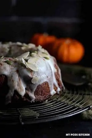 Photo of a pumpkin bundt cake against a dark background.