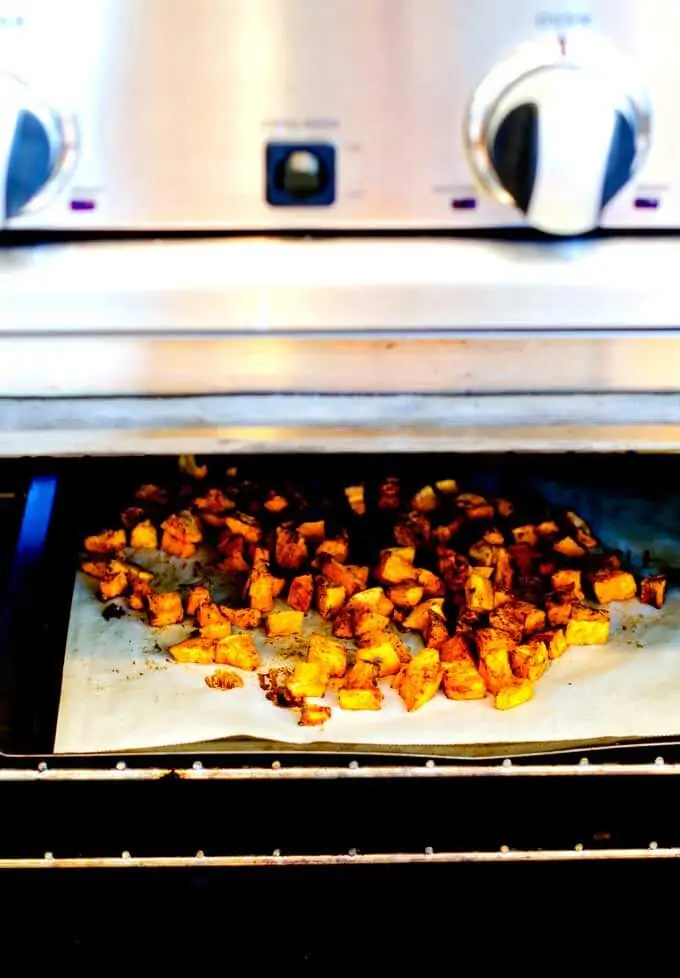 Photo of sweet potatoes roasting in preparation to make a Sweet Potato Quinoa Salad