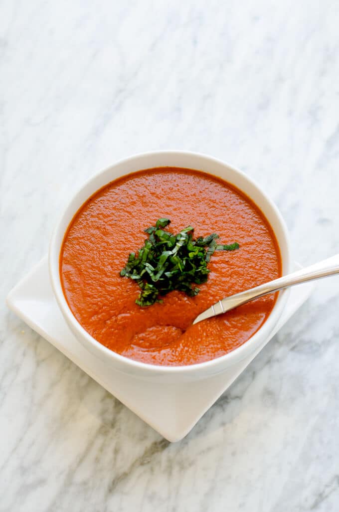 Bowl of Roasted Red Pepper and Tomato Soup on a white background.