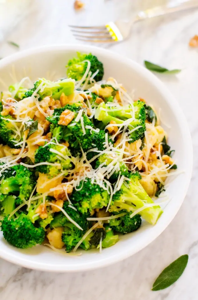 Photo Gnocchi with Broccoli, Sage & Parmesan on a white plate.