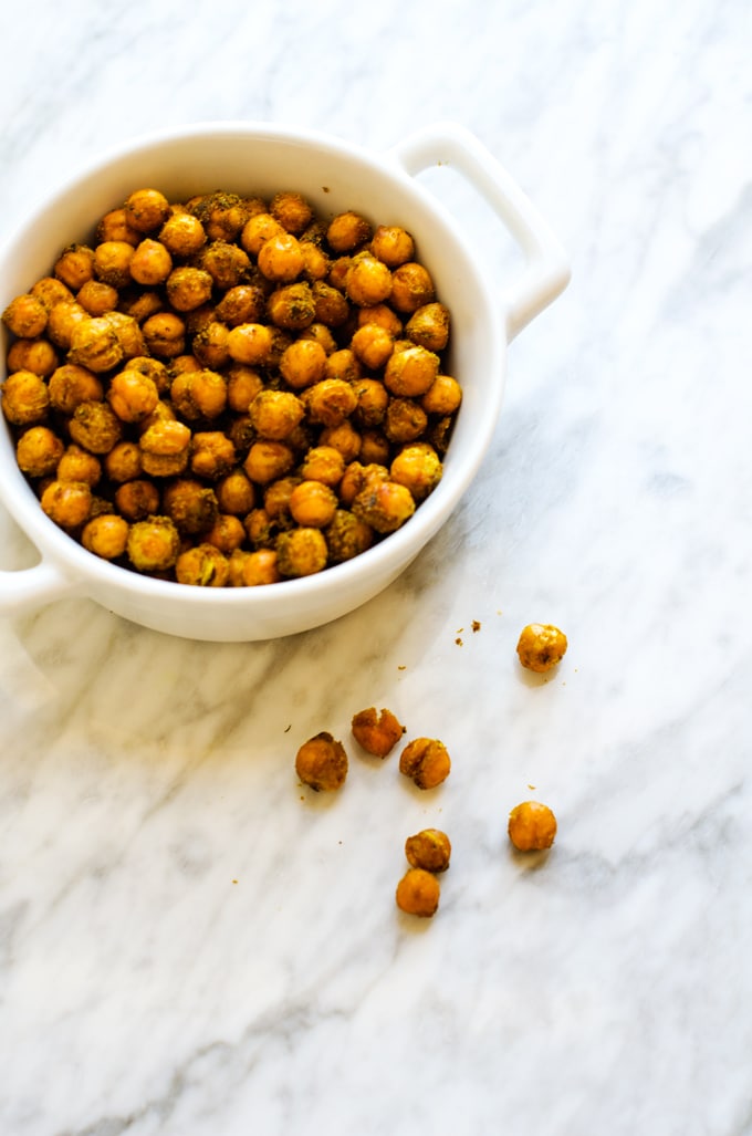 Curried Roasted Chickpeas in a bowl on a white marble background
