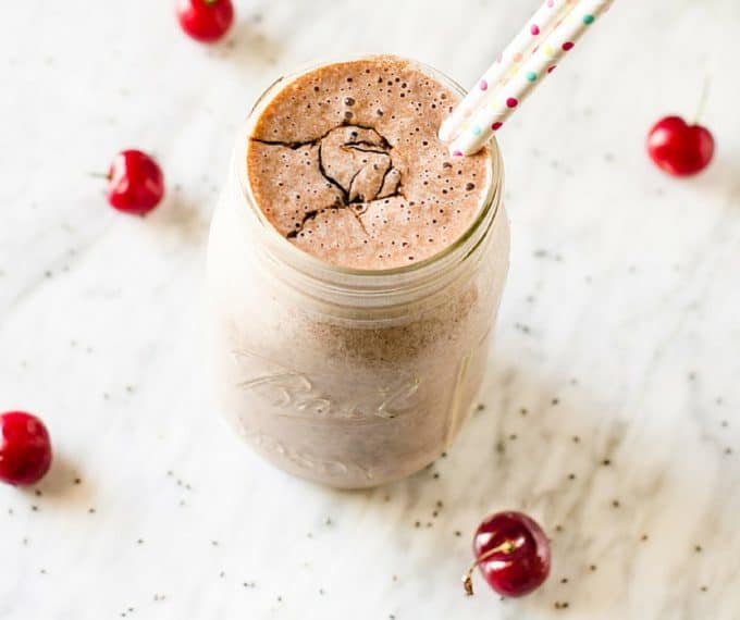 Photo of a cherry chocolate smoothie in a mason jar.