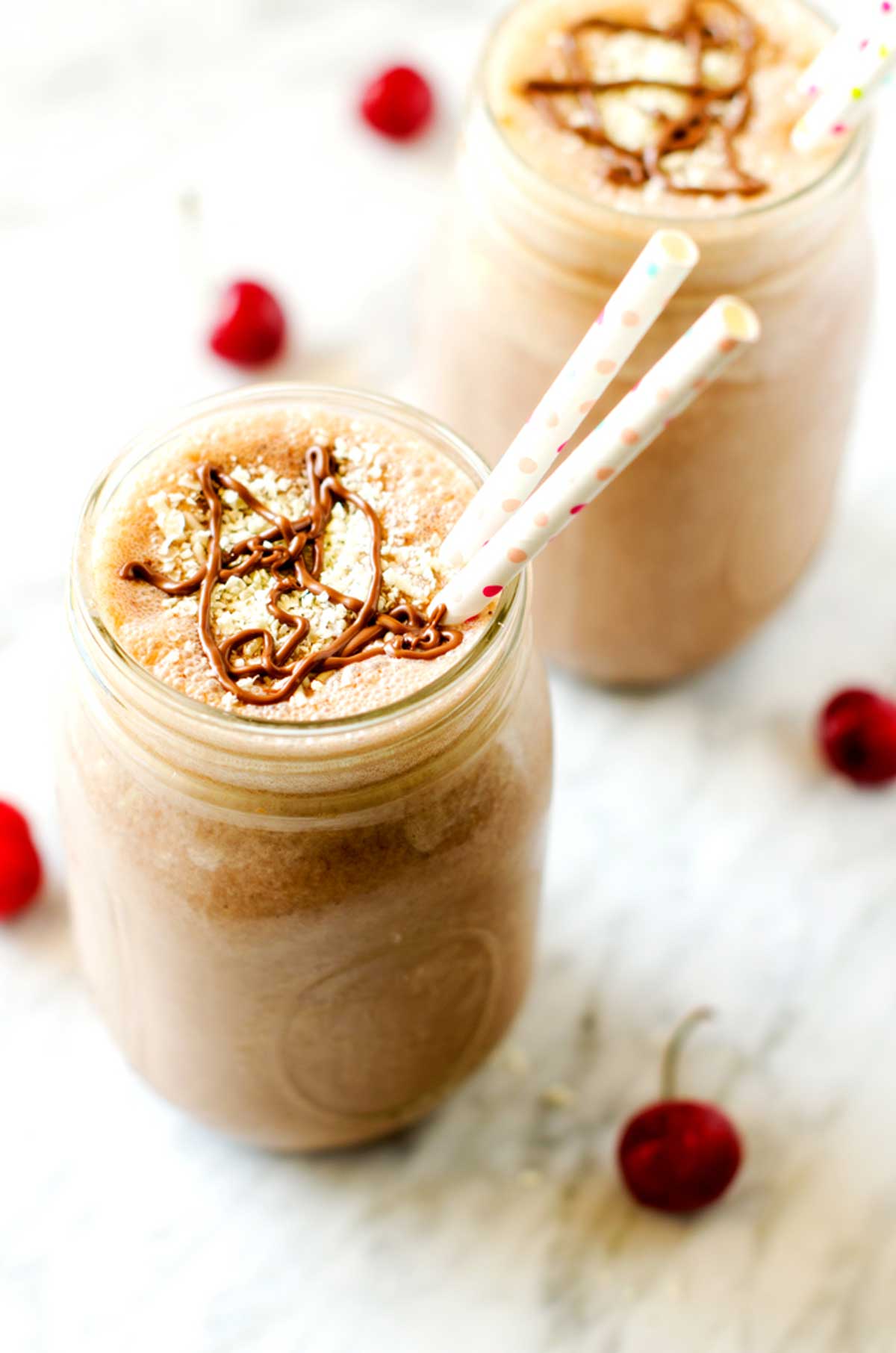 Photo of a chocolate peanut butter smoothie in a mason jar.
