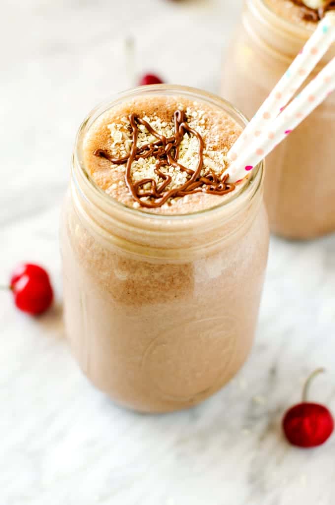 Photo of Chocolate Peanut Butter Smoothie without banana in a glass jar drizzled with chocolate sauce