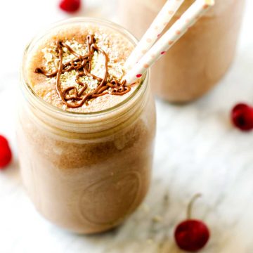 Square photo of a chocolate peanut butter smoothie in a mason jar.