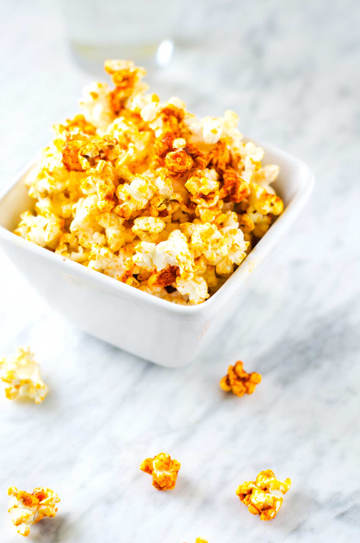 Side photo of a white bowl with garlic popcorn.