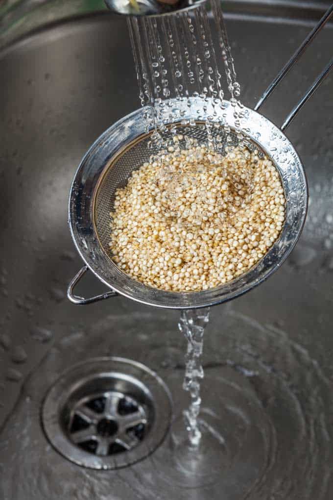 Photo of quinoa being rinsed prior to cooking quinoa.