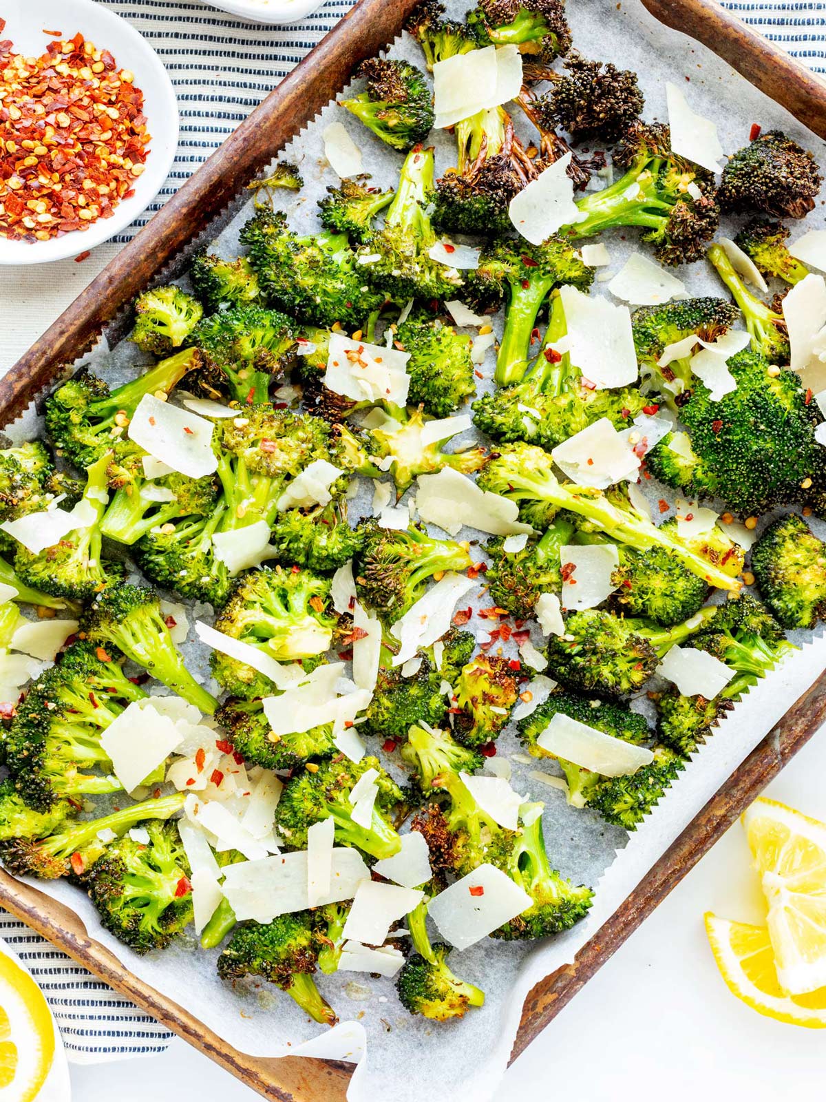 Overhead photo of a parchment lined sheet pan with garlic roasted broccoli.