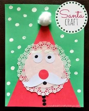 Photo of a Santa craft for little kids on a green piece of paper.
