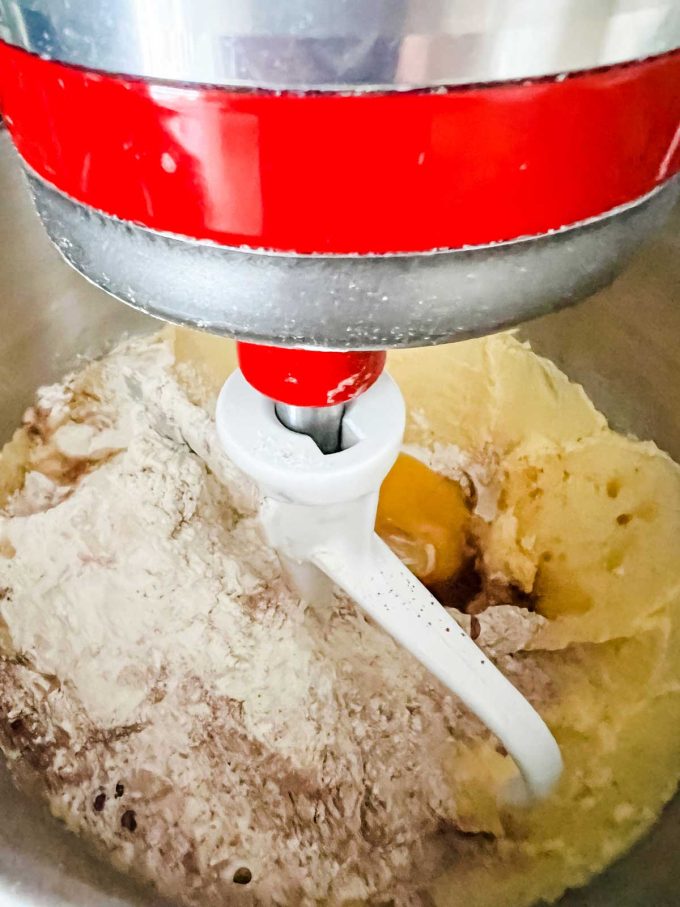 Photo of butter and sugar in a stand mixer that has just had flour, egg, cocoa powder, salt, and baking powder added to it.
