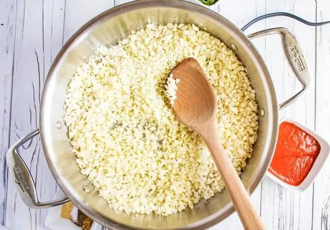 Cauliflower Spanish rice recipe cooking in a skillet