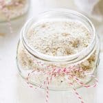 Square photo of homemade face scrub in a small glass jar.