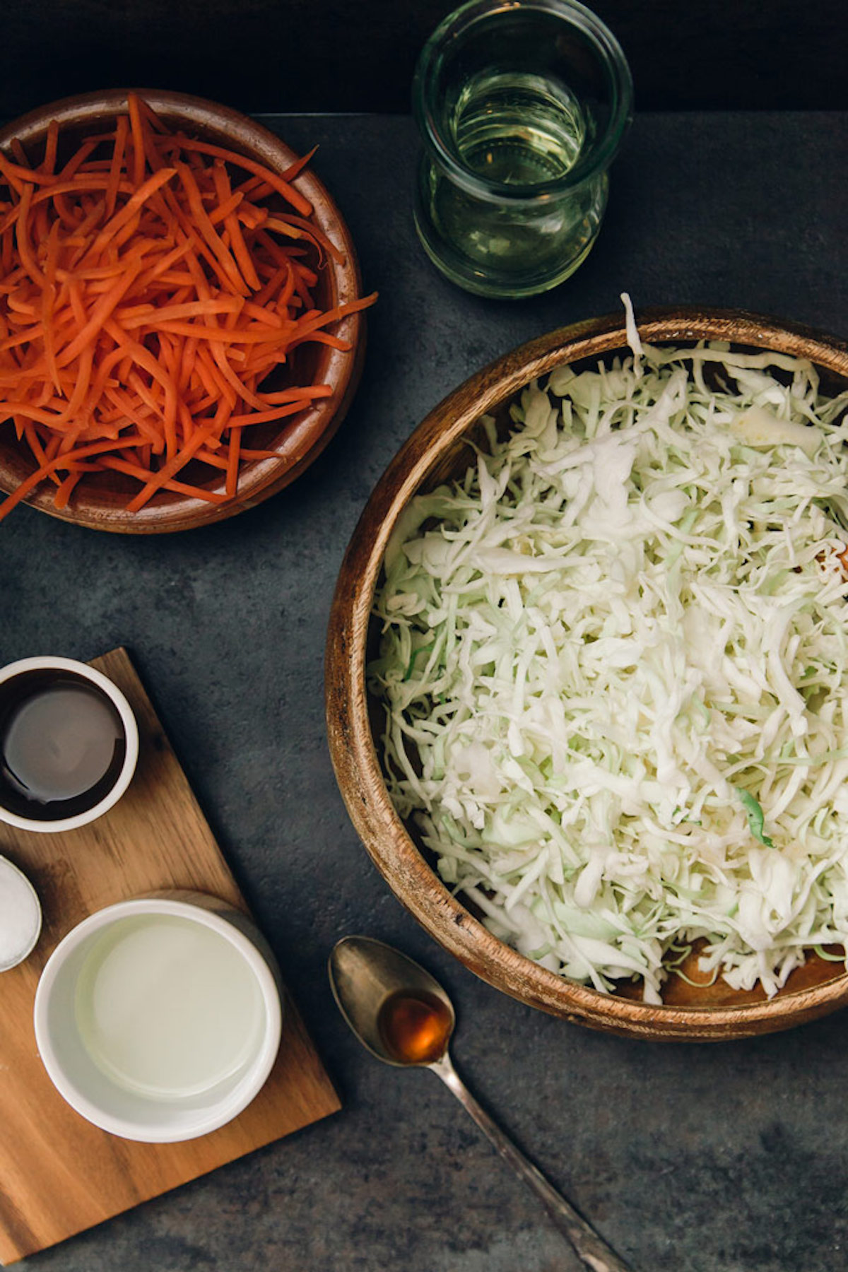 Overhead photo of shredded cabbage, carrots, and dressing ingredients.
