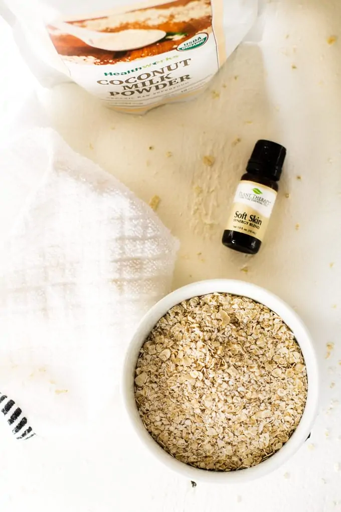 Photo of coconut milk powder, soft skin essential oil, and oatmeal.