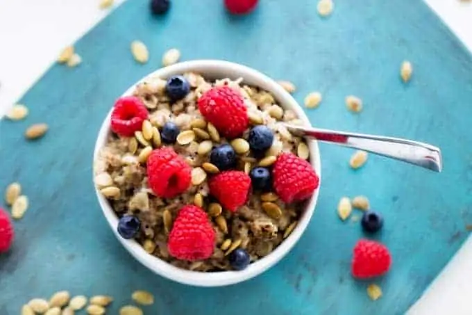 Horizontal Shot of Quinoa & Oats Breakfast Bowl with berries on top.