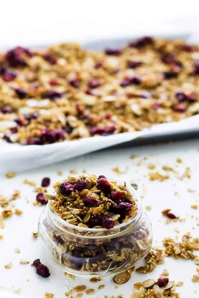 Gluten Free Quinoa Granola on a sheet plan and in a jar.