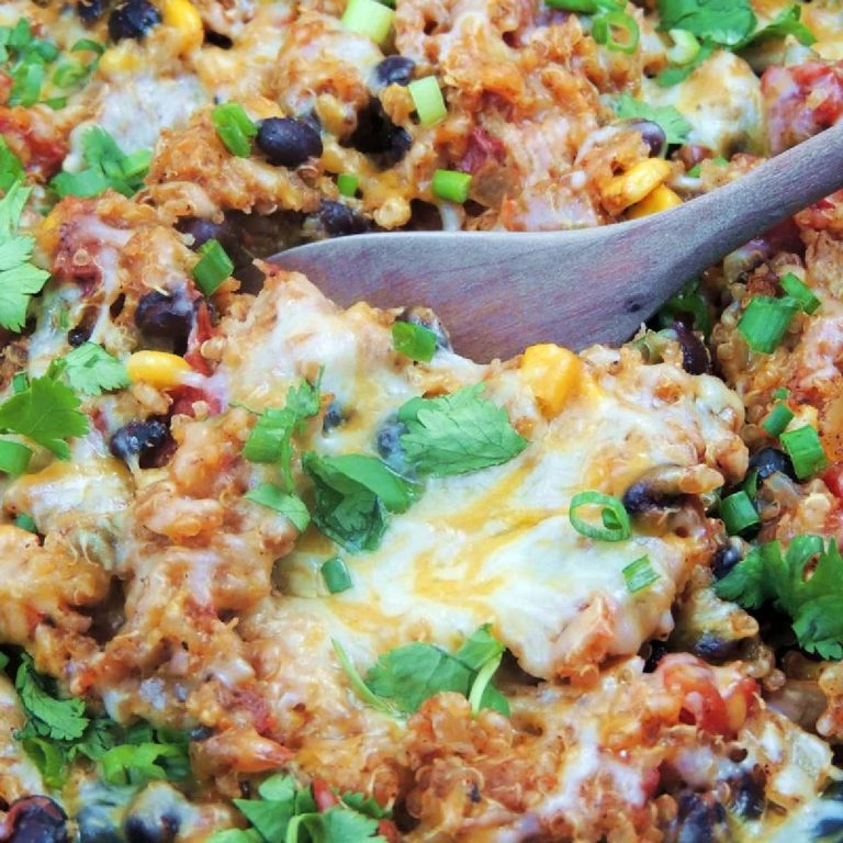 Close up photo of slow cooker chicken enchilada quinoa with a spoon in it.