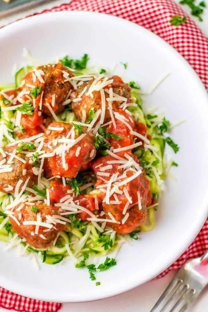 Overhead shot of gluten free meatballs without breadcrumbs served with marinara and zoodles