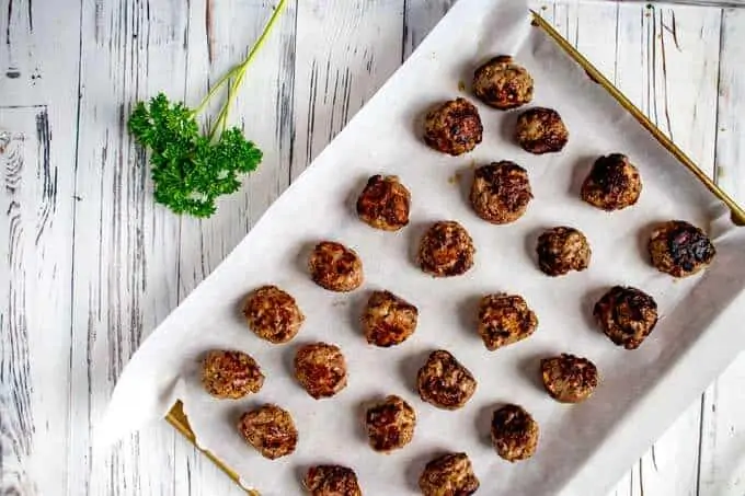 Baking sheet of cooked Gluten Free Meatballs Without Breadcrumbs.