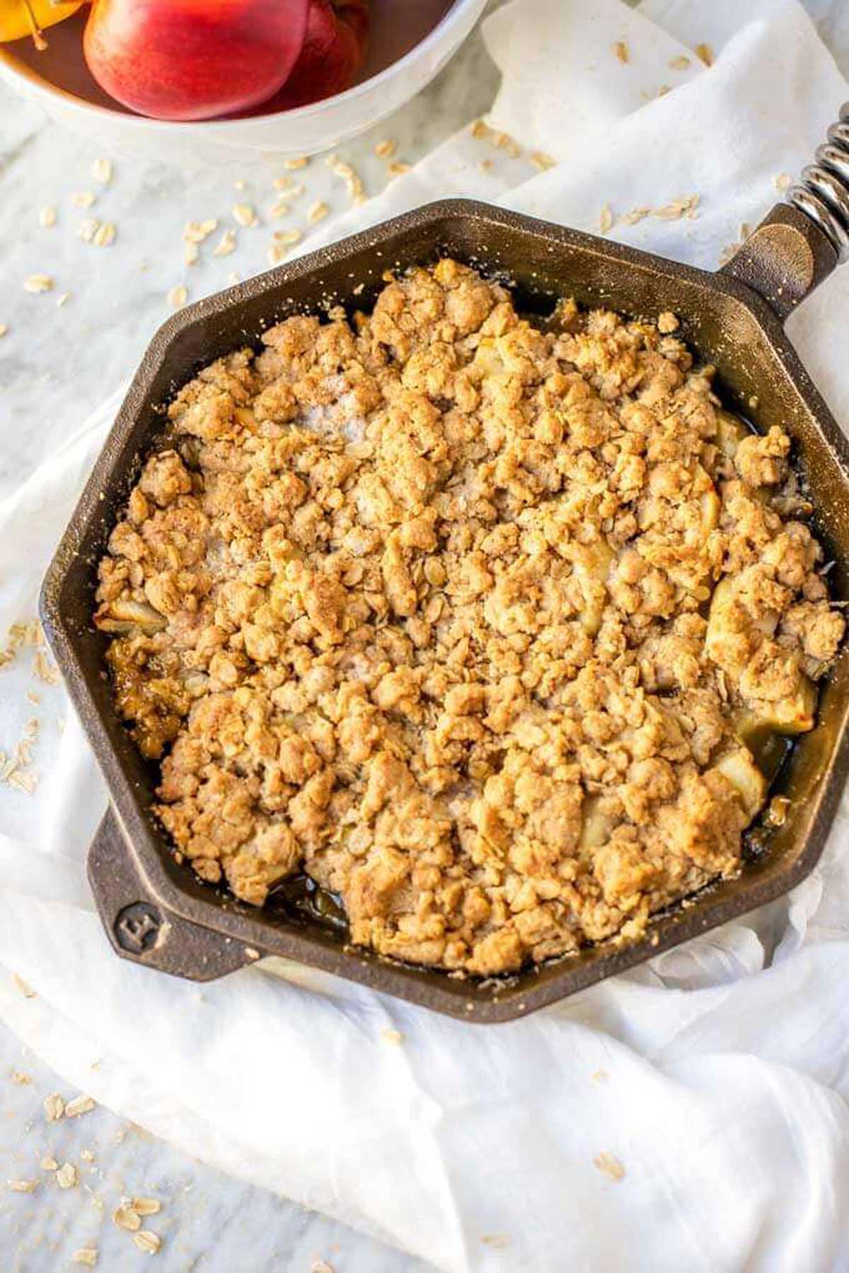 Overhead photo of a cast iron skillet with a gluten free apple crisp.