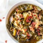 Photo of Slow Cooker Collard Greens in a white bowl.