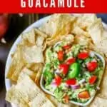 Photo of Bacon Guacamole in a small dish surrounded by tortilla chips with the text "Bacon Guacamole" above it.