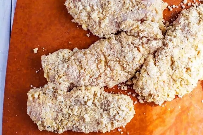 Photo of breaded chicken that is ready to cook.