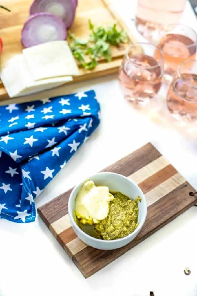 Photo of pesto and mayonnaise in a small white bowl for an Italian Burger Recipe. 