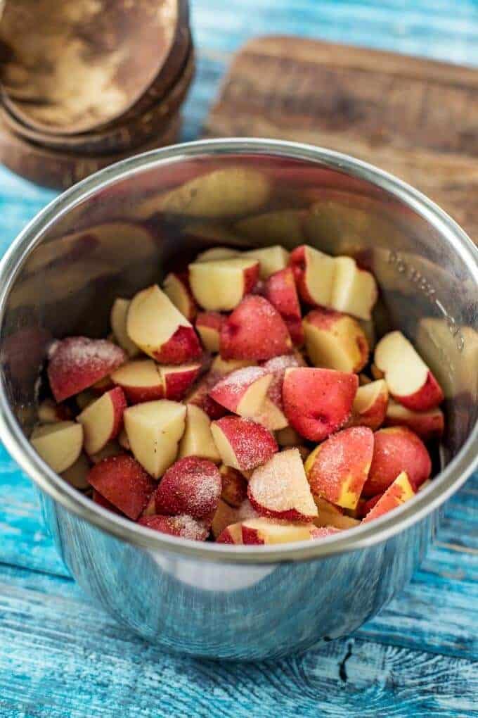 Instant Pot with cut red potatoes in it.