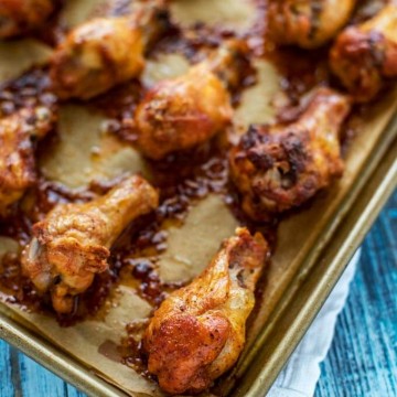 Photo of cooked Healthy Chicken Wings on a parchment lined baking sheet.