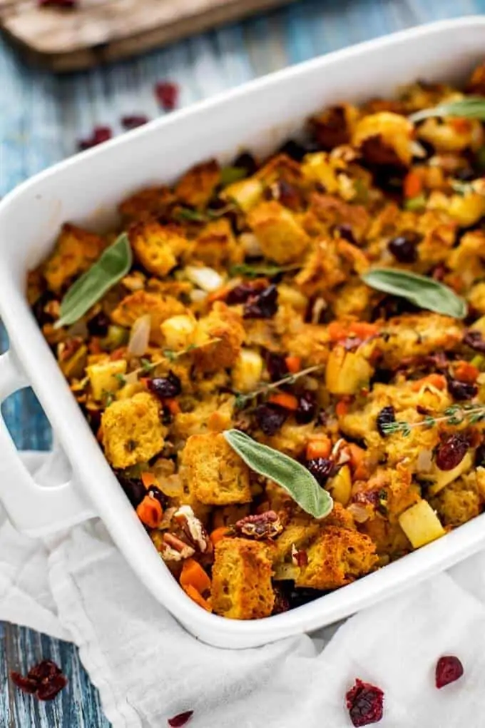 Cooked gluten free stuffing in a white casserole dish.