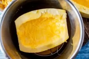 Photo of a halved spaghetti squash in an Instant Pot on top of a trivet.