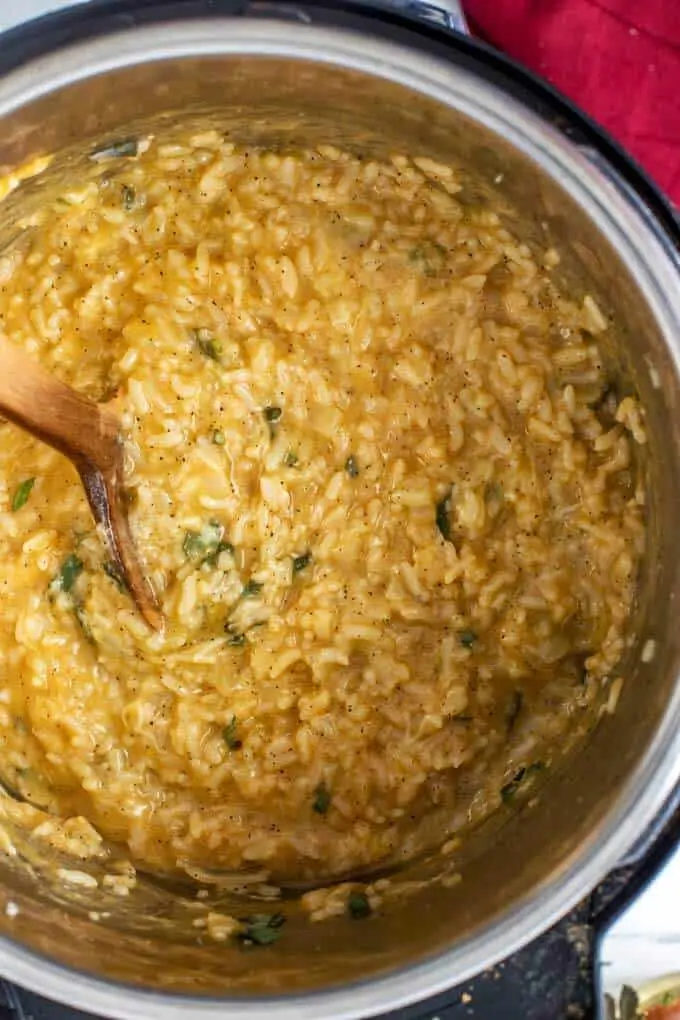 Photo of a prepared Instant Pot Risotto Recipe in an Instant Pot with a Spoon.